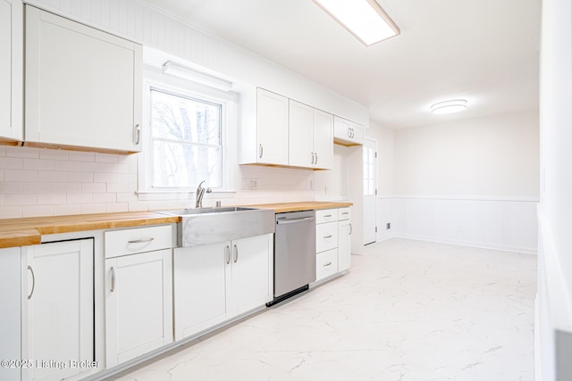 kitchen featuring a sink, wood counters, white cabinetry, and dishwasher