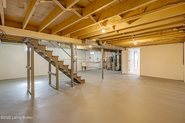 unfinished basement with heating unit, stairs, and a sink