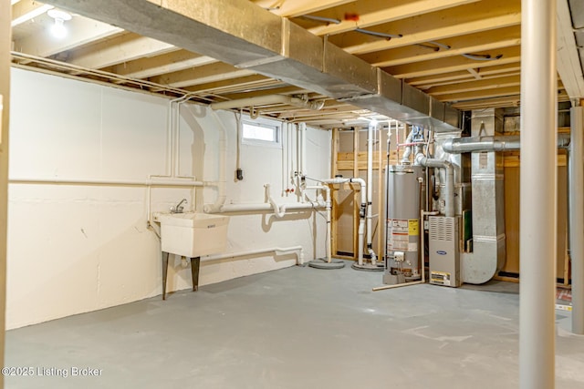 basement with water heater and a sink