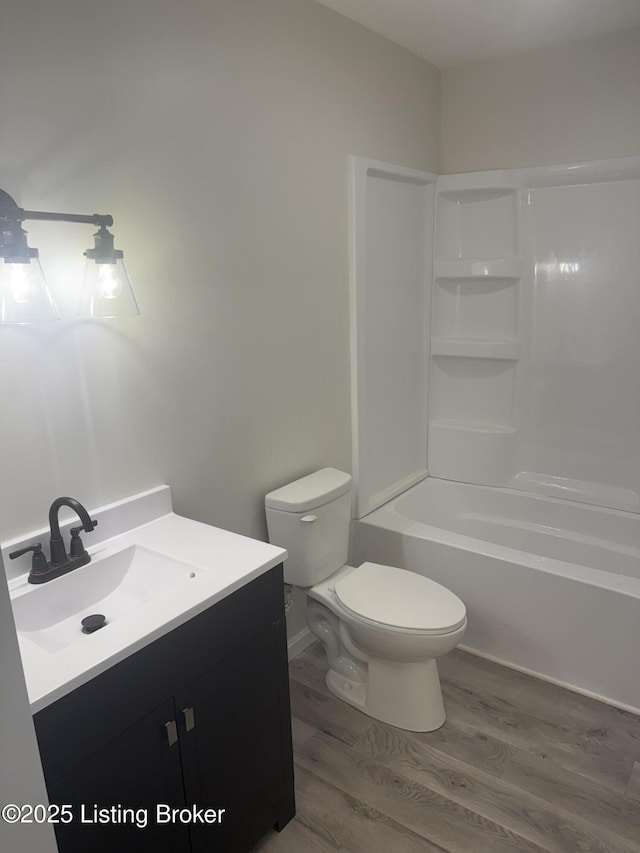 full bathroom with vanity, shower / bathing tub combination, wood finished floors, and toilet