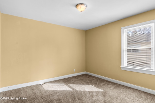 spare room with carpet floors and baseboards