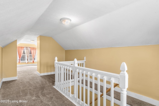 additional living space featuring lofted ceiling, carpet, and baseboards