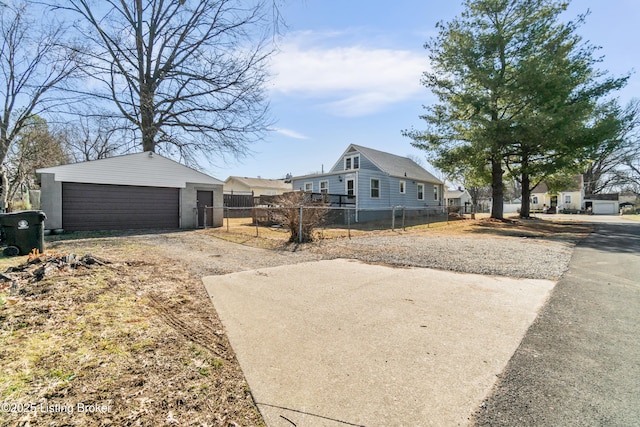 view of property exterior featuring an outbuilding, a detached garage, and fence