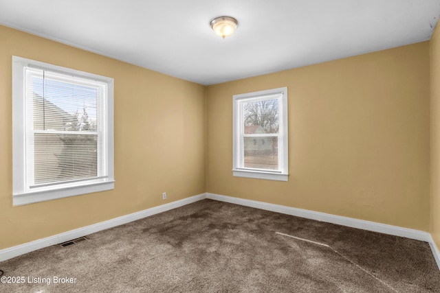 unfurnished room featuring carpet floors, baseboards, and visible vents