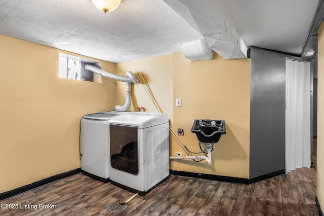 laundry room featuring baseboards, washing machine and clothes dryer, and wood finished floors