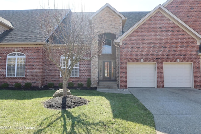 view of front of house with brick siding, concrete driveway, an attached garage, a front yard, and stone siding