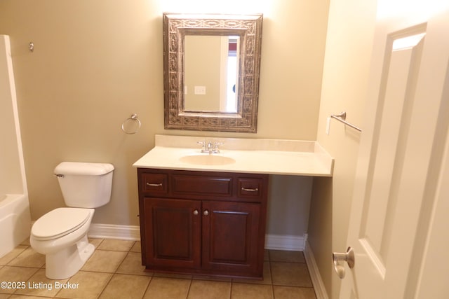 bathroom featuring a tub, vanity, toilet, and tile patterned floors