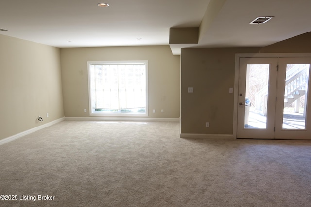 carpeted empty room with visible vents and baseboards