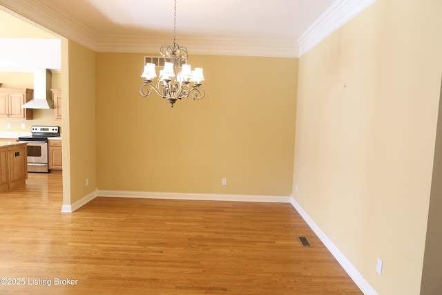 unfurnished dining area featuring baseboards, ornamental molding, and light wood-style floors