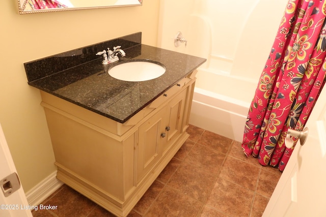 full bathroom featuring tile patterned flooring, baseboards, shower / tub combo with curtain, and vanity