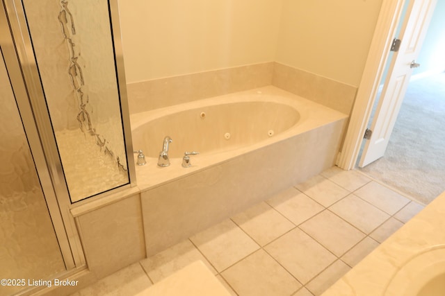 full bathroom featuring a whirlpool tub and tile patterned floors