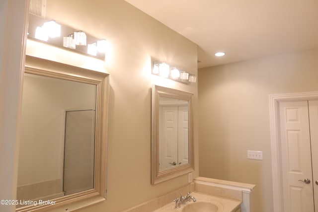 bathroom with recessed lighting and a sink