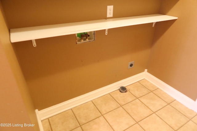 laundry room featuring laundry area, baseboards, hookup for a washing machine, tile patterned flooring, and electric dryer hookup