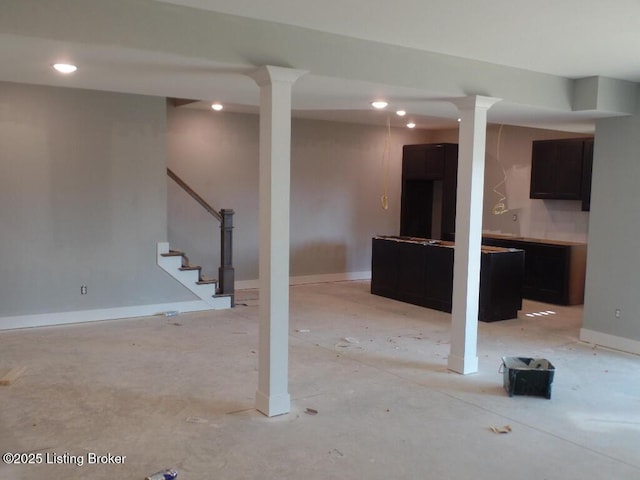 finished basement with stairs, baseboards, and recessed lighting