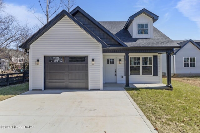 view of front of home featuring roof with shingles, concrete driveway, covered porch, a front yard, and a garage