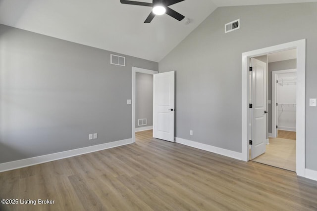 unfurnished bedroom with wood finished floors, visible vents, and baseboards