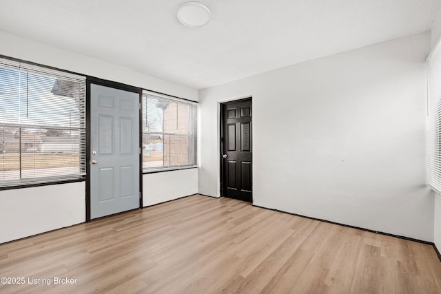 unfurnished bedroom featuring light wood-style flooring