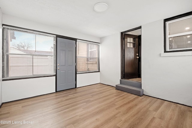 unfurnished room with light wood-style flooring