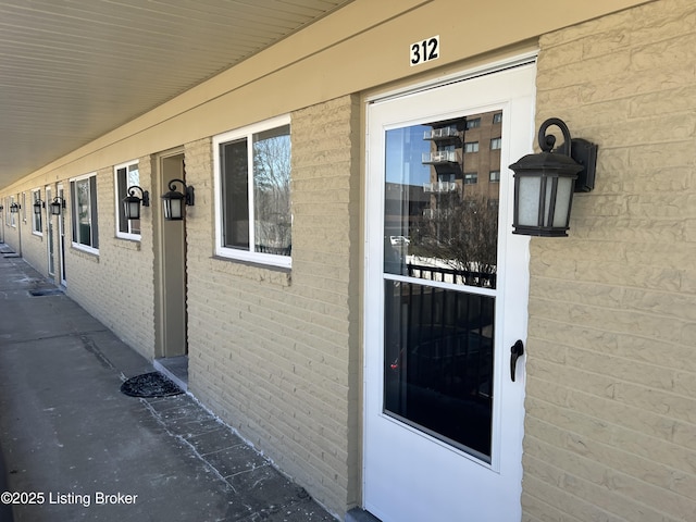 property entrance featuring brick siding