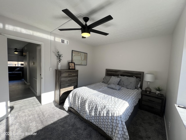 bedroom with ceiling fan, carpet floors, and visible vents