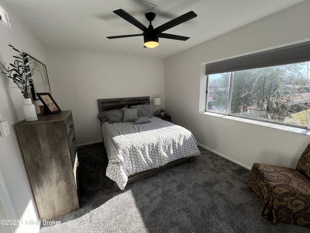 bedroom with ceiling fan, carpet flooring, and baseboards