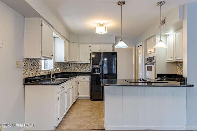 kitchen featuring visible vents, decorative backsplash, a sink, a peninsula, and black appliances