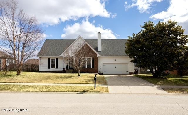 view of front of property with driveway, a front lawn, a chimney, and an attached garage