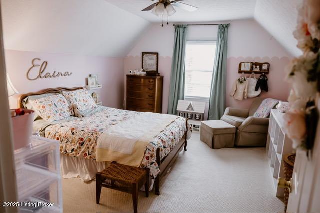 carpeted bedroom with vaulted ceiling and ceiling fan