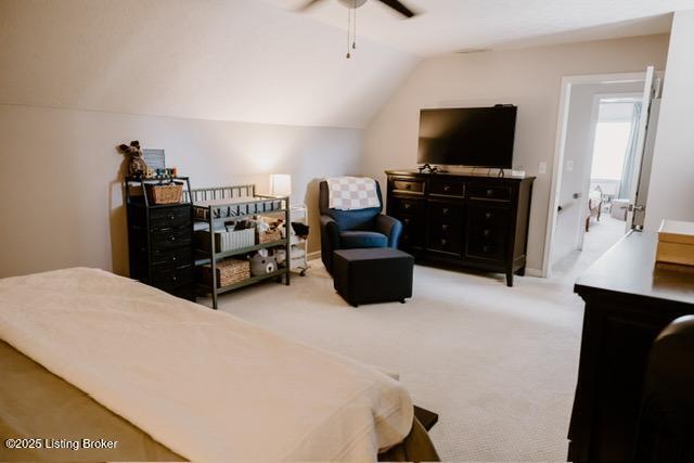 carpeted bedroom with lofted ceiling and a ceiling fan