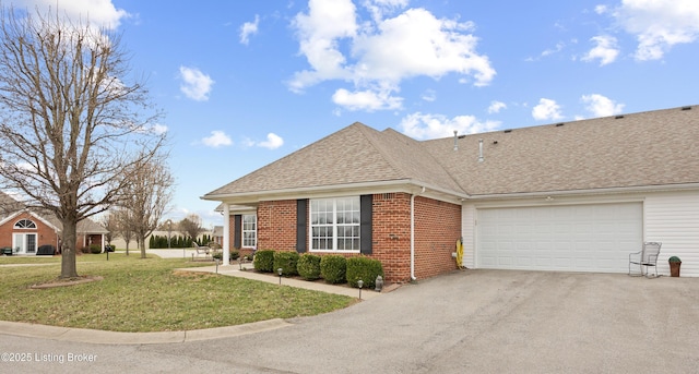 ranch-style house featuring driveway, a garage, roof with shingles, a front lawn, and brick siding