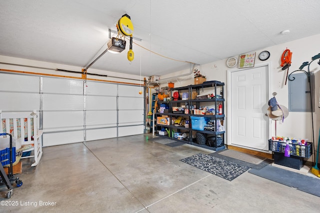 garage with electric panel and a garage door opener