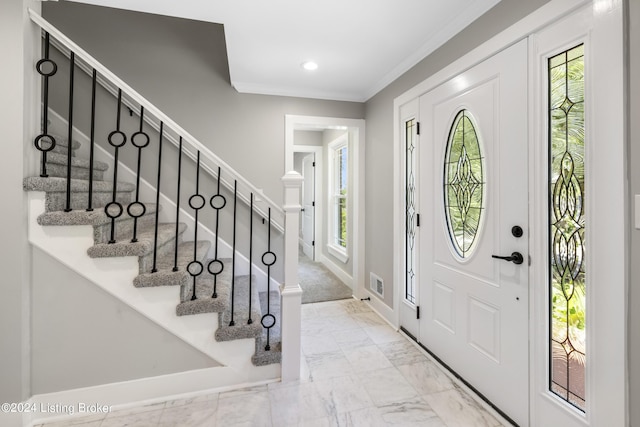 foyer entrance with recessed lighting, visible vents, marble finish floor, stairway, and crown molding