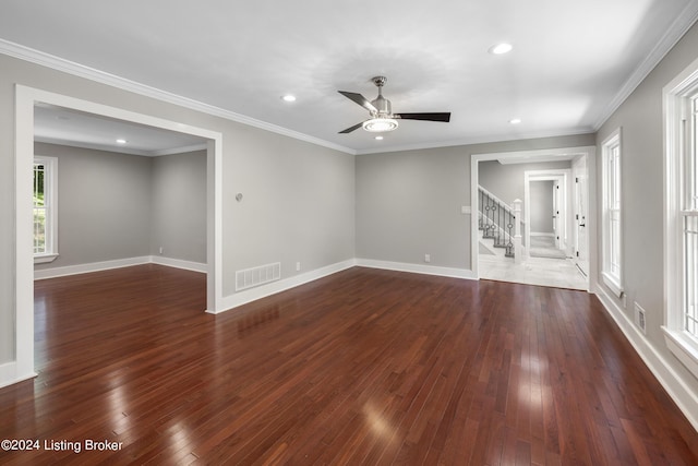 unfurnished room with baseboards, visible vents, dark wood finished floors, and ornamental molding