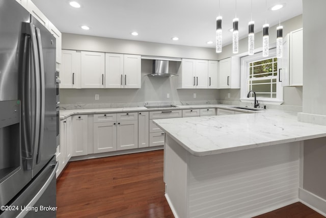 kitchen featuring black electric stovetop, a peninsula, a sink, stainless steel fridge with ice dispenser, and wall chimney exhaust hood