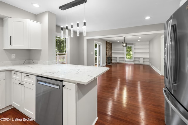 kitchen with white cabinetry, stainless steel appliances, dark wood-type flooring, and open floor plan