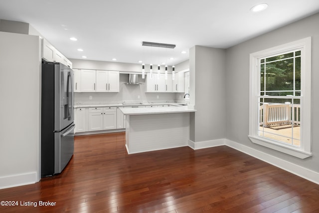 kitchen with dark wood-style floors, stainless steel fridge, baseboards, and light countertops