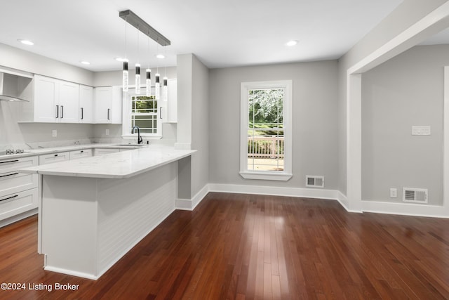 kitchen featuring a sink, visible vents, and white cabinetry