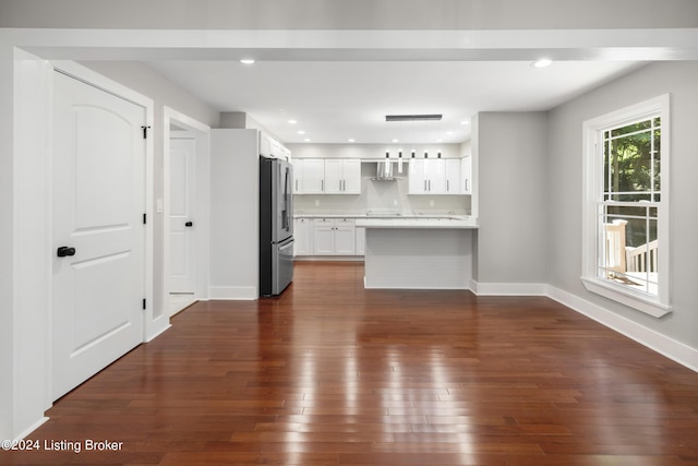 unfurnished living room with dark wood-style floors, visible vents, baseboards, and recessed lighting