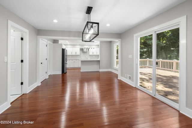 interior space featuring dark wood-style floors, recessed lighting, visible vents, and baseboards