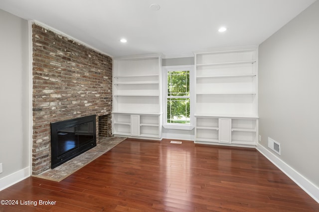 unfurnished living room featuring a brick fireplace, visible vents, wood-type flooring, and baseboards