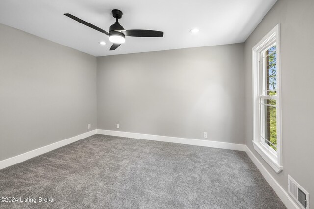 empty room with plenty of natural light, visible vents, and baseboards