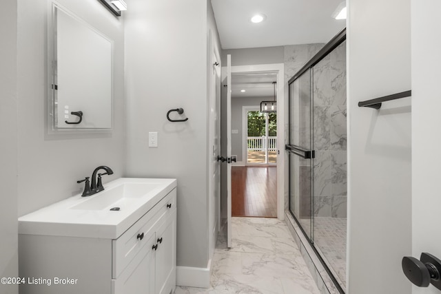 bathroom with recessed lighting, vanity, baseboards, marble finish floor, and a stall shower