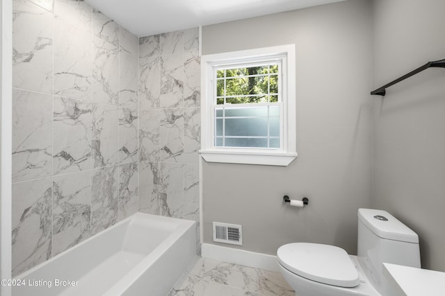 bathroom featuring toilet, visible vents, baseboards, marble finish floor, and shower / washtub combination