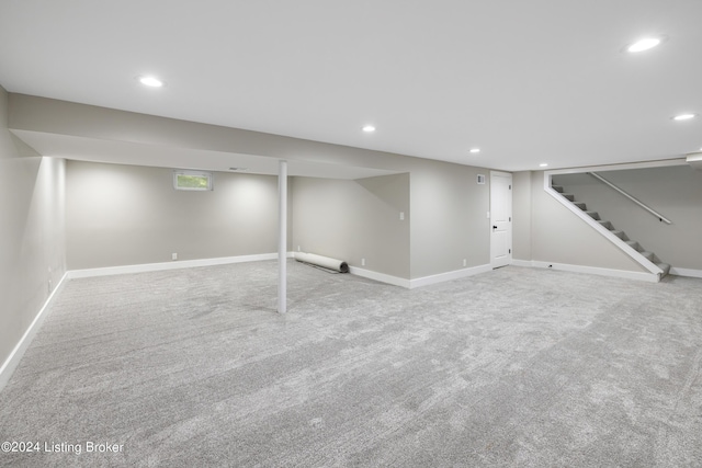 finished below grade area with baseboards, stairway, carpet, and recessed lighting