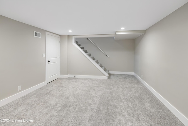 finished basement featuring baseboards, visible vents, stairs, carpet floors, and recessed lighting