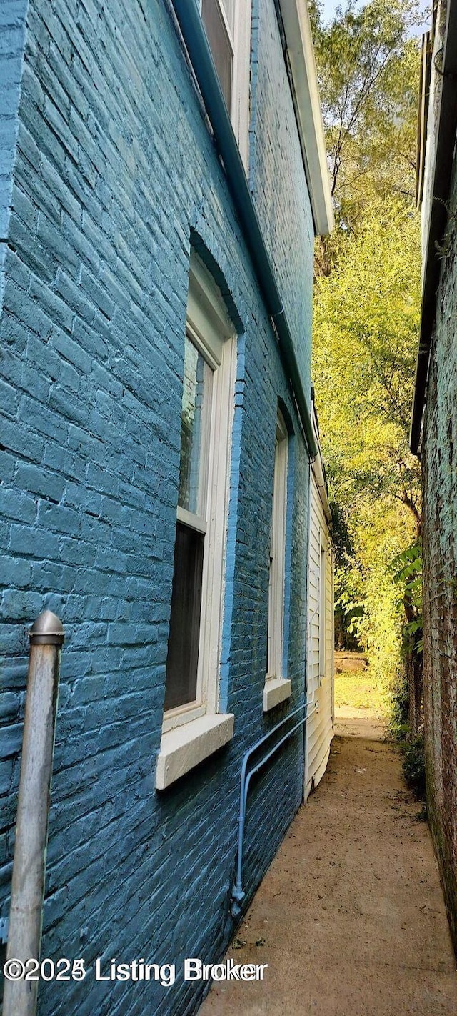 view of property exterior with brick siding