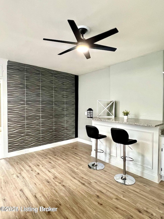 interior space with ceiling fan and wood finished floors