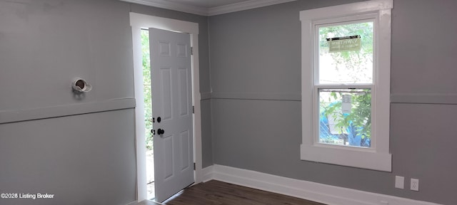 entrance foyer featuring ornamental molding, dark wood finished floors, and baseboards