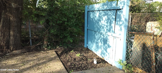 view of outbuilding featuring fence