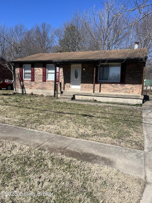 ranch-style home with brick siding and a front lawn